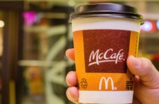 A customer holds a cup of Coffee served by McCafe out of a
